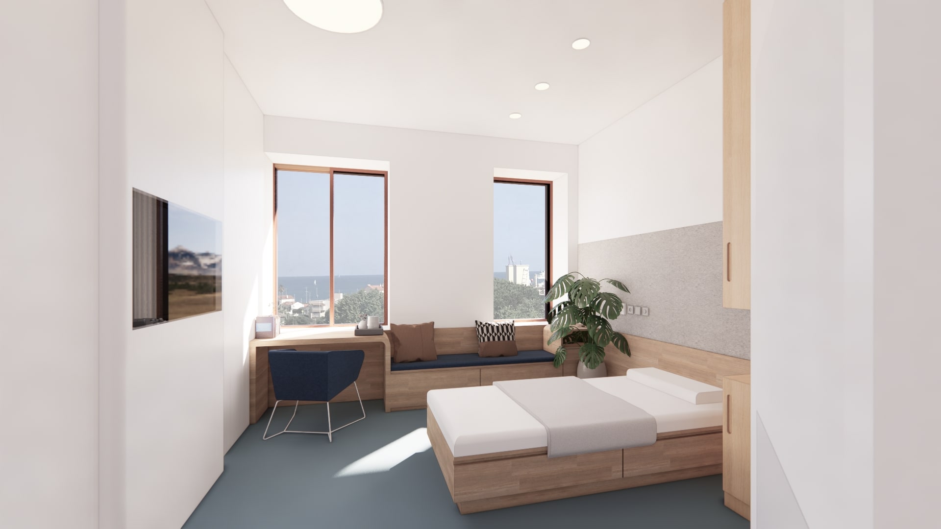 Chambre patient lumineuse avec vue panoramique au Centre Hospitalier à Antibes, révélant l'approche d'A26 pour le confort des patients et l'ergonomie hospitalière à travers un design intérieur moderne